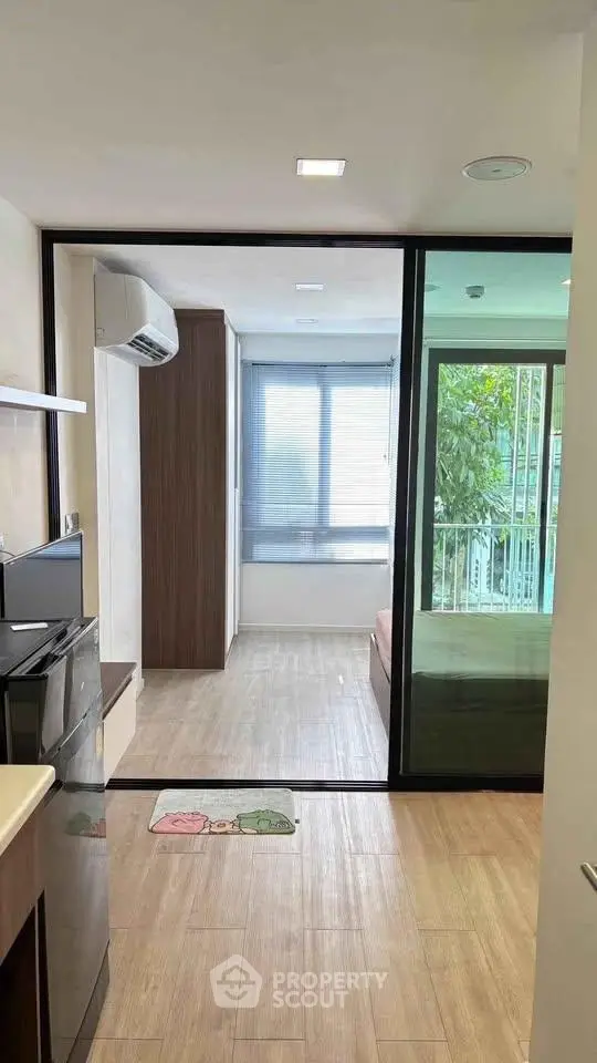 Modern apartment interior with open layout and large windows for natural light.
