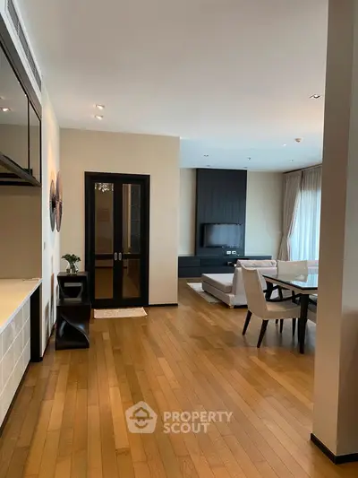 Spacious modern living room with wooden flooring and elegant decor