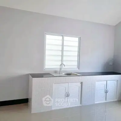 Modern minimalist kitchen with sleek countertops and white cabinetry