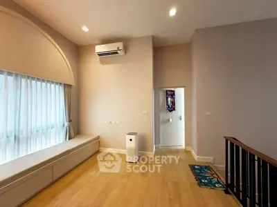 Spacious modern living room with large window and air conditioning
