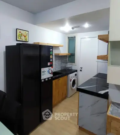 Modern kitchen with sleek black appliances and stylish open shelving