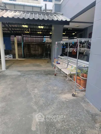 Spacious outdoor area with covered patio and seating, ideal for relaxation and gatherings.