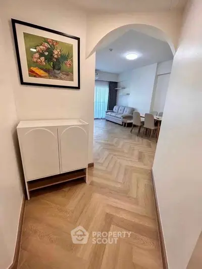 Stylish hallway leading to a cozy living room with elegant decor and dining area.