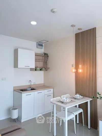 Modern kitchen with sleek design, open layout, and stylish lighting in a cozy apartment.