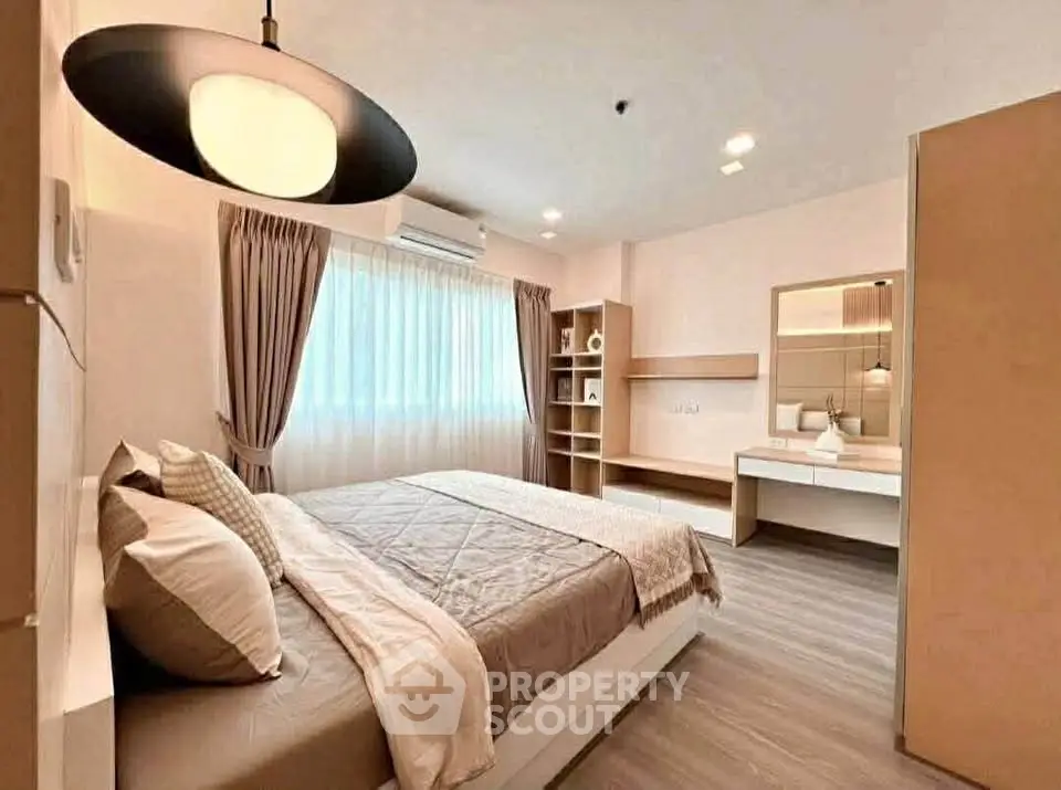 Spacious modern bedroom with elegant decor and ample natural light
