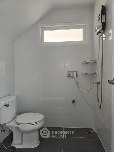 Modern minimalist bathroom with sleek white tiles and compact design