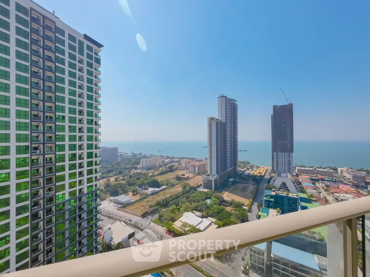 Stunning high-rise balcony view of cityscape and ocean horizon