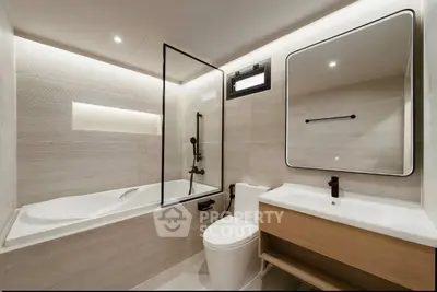 Modern bathroom with sleek design, featuring a bathtub and elegant fixtures.