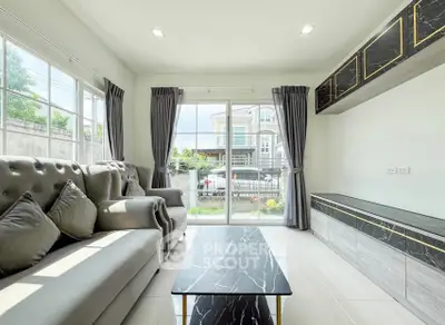 Bright modern living room with large windows and stylish furniture