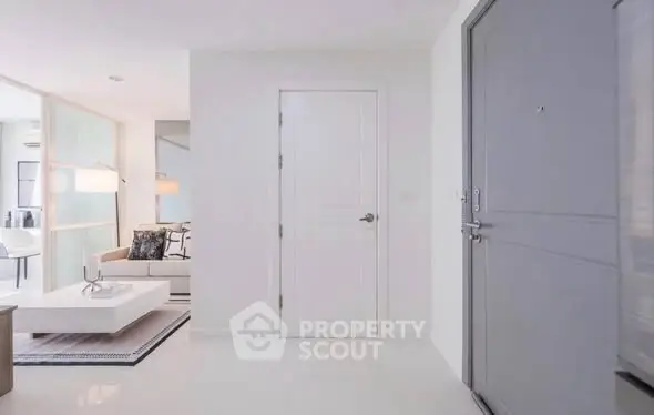 Modern apartment entrance with sleek living room and stylish decor