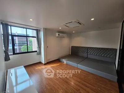 Modern living room with hardwood floors and large window