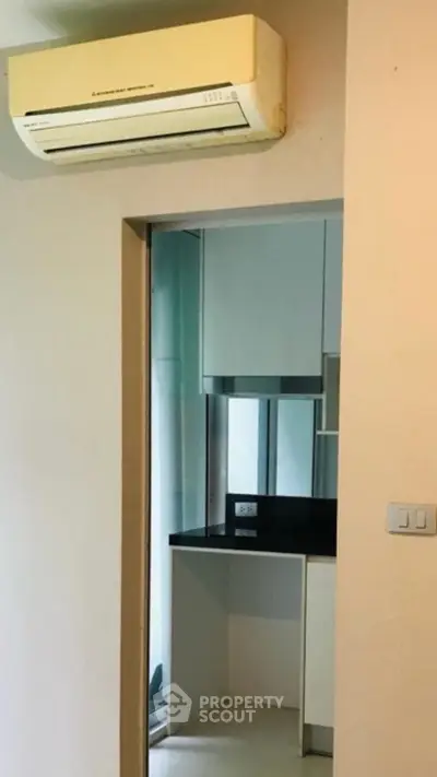 Compact kitchen with air conditioning unit in modern apartment