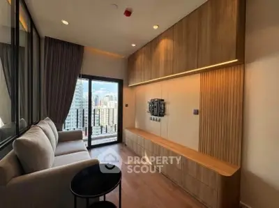 Modern living room with city view, featuring sleek wooden cabinetry and cozy seating.