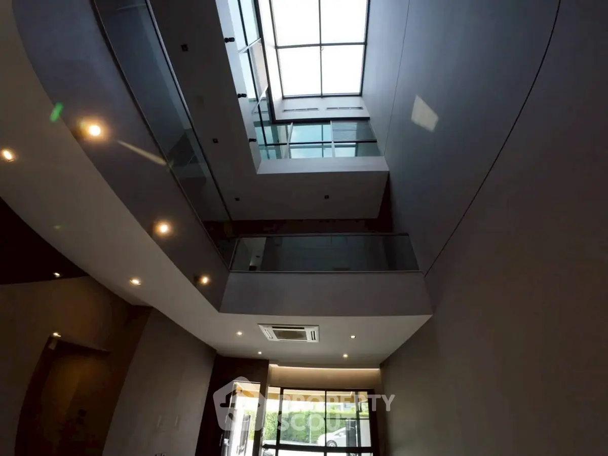 Modern building interior with skylight and glass railings