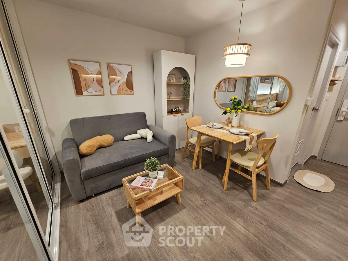 Cozy living room with modern decor, featuring a comfortable sofa, dining table, and stylish wall art.