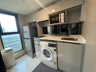 Modern kitchen with sleek appliances and city view window