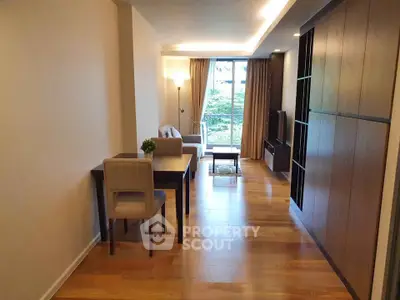 Spacious living room with modern decor and large window view.