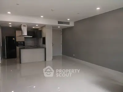 Spacious modern kitchen with sleek design and open layout in a contemporary apartment.