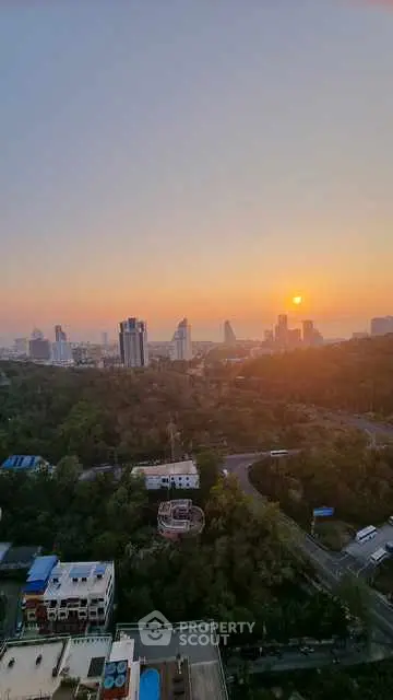 Stunning cityscape view at sunset with lush greenery and skyline