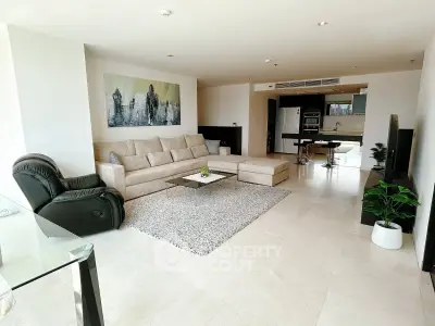 Spacious modern living room with elegant decor and open kitchen layout, perfect for stylish urban living.
