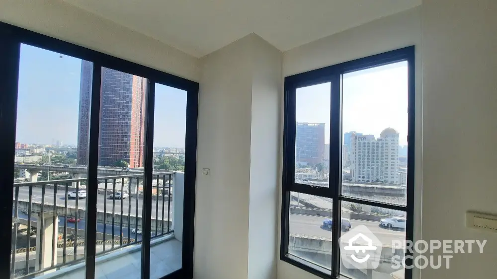 Bright corner unit with stunning city view and large windows in modern apartment.