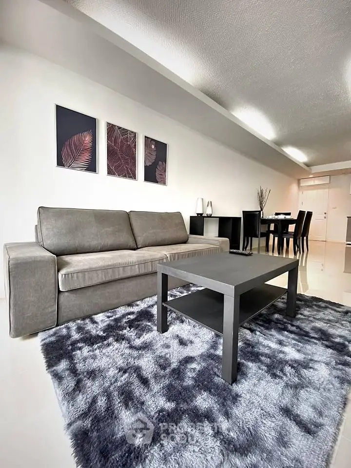 Modern living room with sleek gray sofa and stylish decor