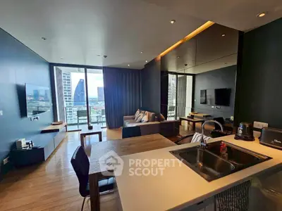 Modern open-plan living room with kitchen, featuring floor-to-ceiling windows and city view.