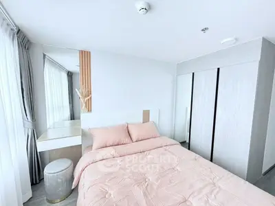 Modern bedroom with soft pink bedding and sleek wardrobe design