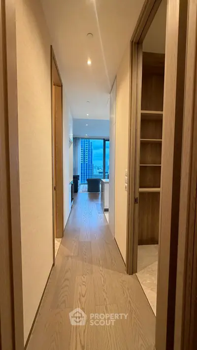 Elegant hallway leading to a modern living room with city view