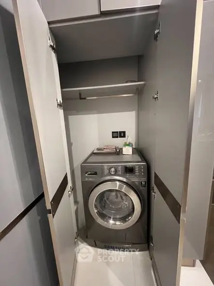 Modern laundry area with Samsung washing machine in sleek cabinet