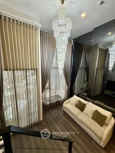 Luxurious living room with elegant chandeliers and floor-to-ceiling windows