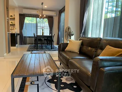 Stylish living room with leather sofa and elegant dining area