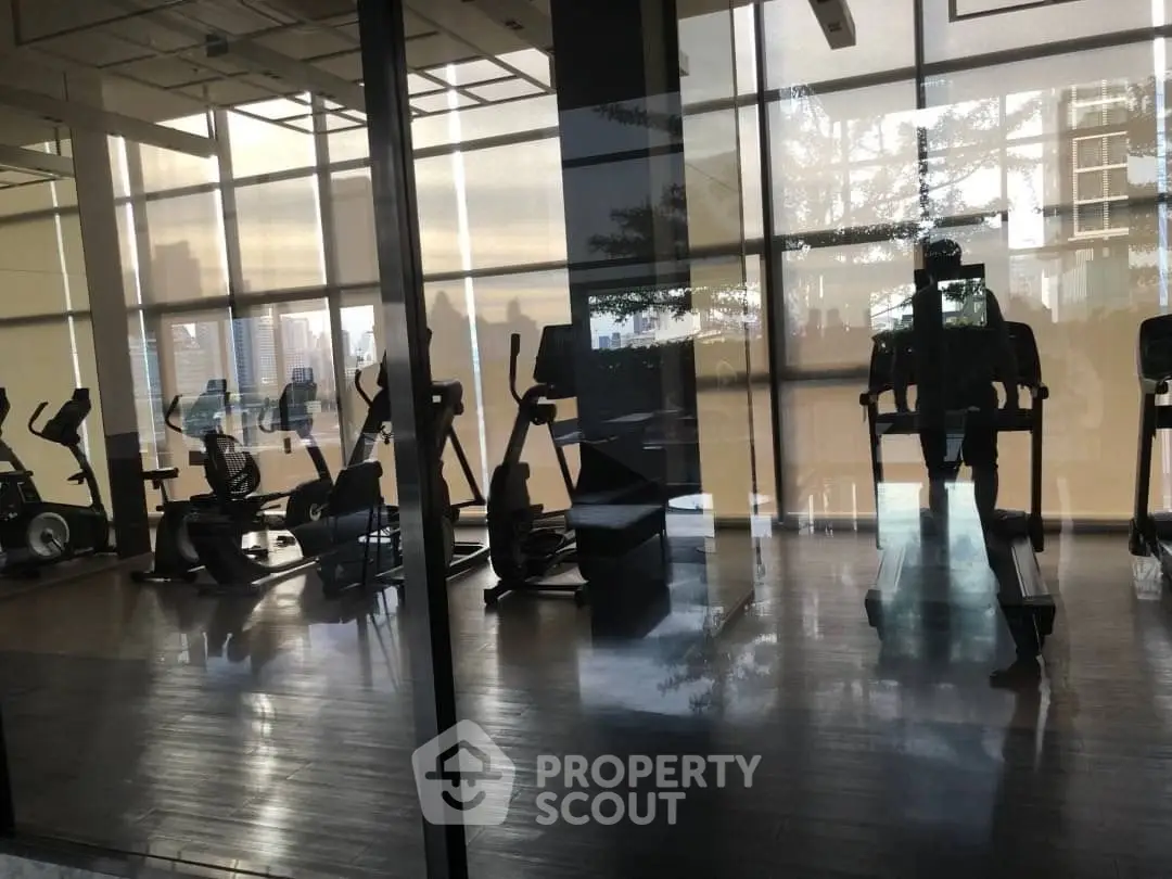 Modern gym with state-of-the-art fitness equipment and city view.