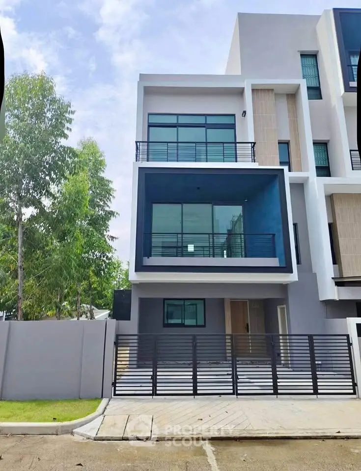 Modern three-story townhouse with sleek design and spacious balconies in a serene neighborhood.