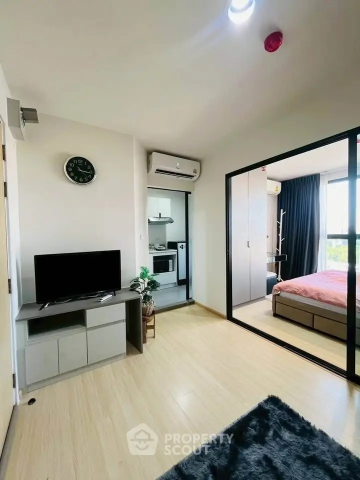 Modern apartment interior with open living room and bedroom view