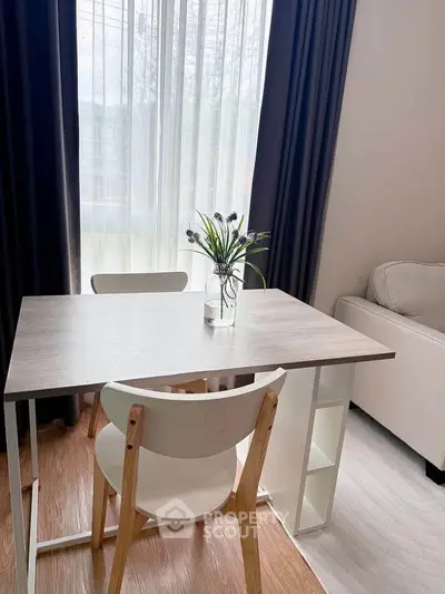 Charming living room with modern table and cozy seating area, perfect for relaxation and entertaining.