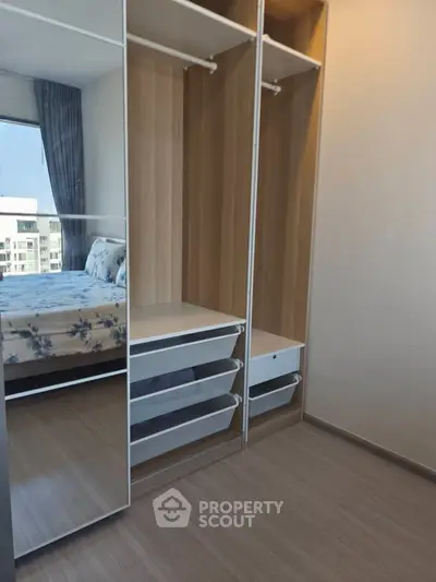 Modern bedroom with built-in wardrobe and large window view