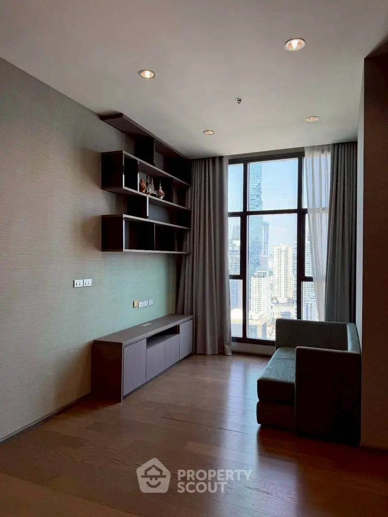 Modern living room with city view, featuring sleek shelving and cozy seating area.