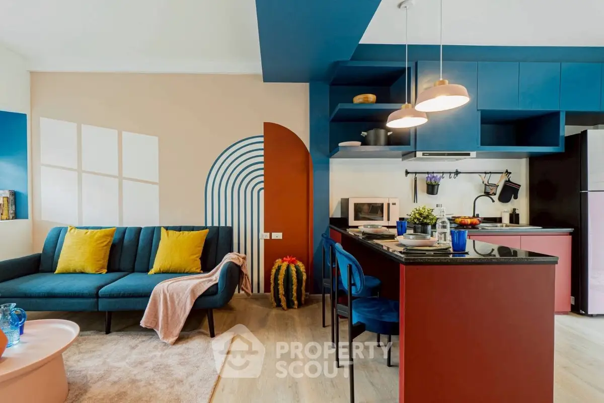 Stylish modern living room with vibrant colors and open kitchen layout, featuring sleek furniture and contemporary design.
