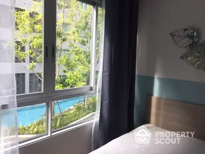 Cozy bedroom with pool view through large window, modern decor