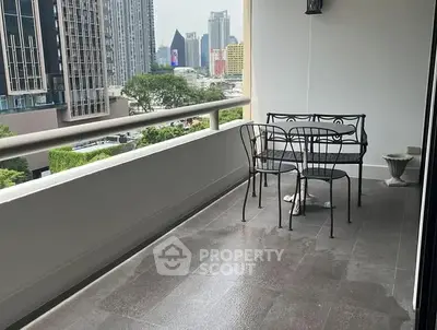 Spacious balcony with city view and elegant outdoor seating.