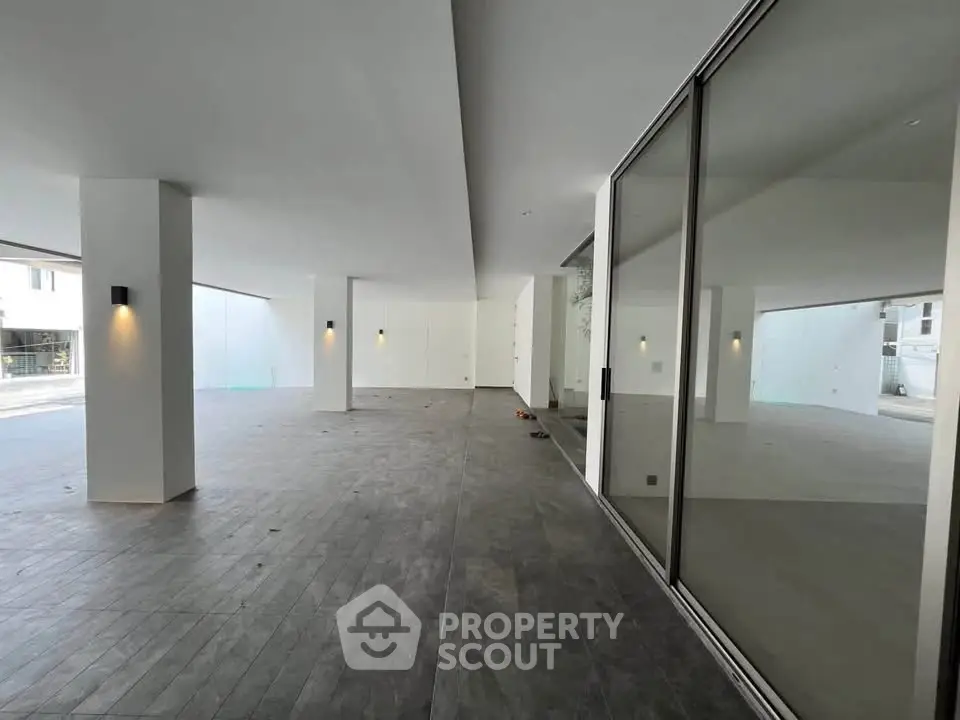 Spacious modern building entrance with sleek design and large glass doors