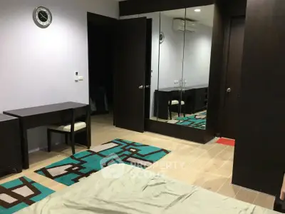 Modern bedroom with mirrored wardrobe and stylish decor