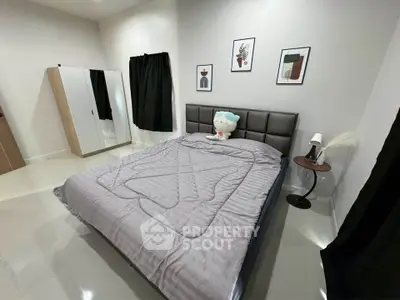 Modern bedroom with stylish decor and cozy bedding in a contemporary apartment.