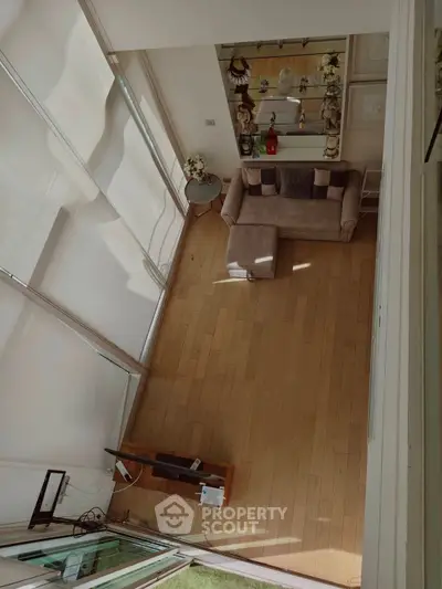 Spacious living room with modern decor and large windows for natural light