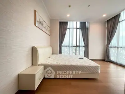 Spacious bedroom with large windows and modern decor