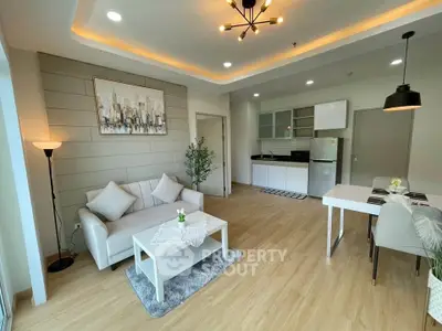 Modern open-plan living room with stylish kitchen and cozy seating area