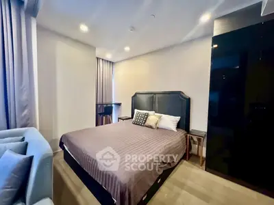 Modern bedroom with stylish decor and cozy ambiance, featuring a comfortable bed and elegant furnishings.