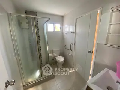 Modern bathroom with glass shower and white fixtures