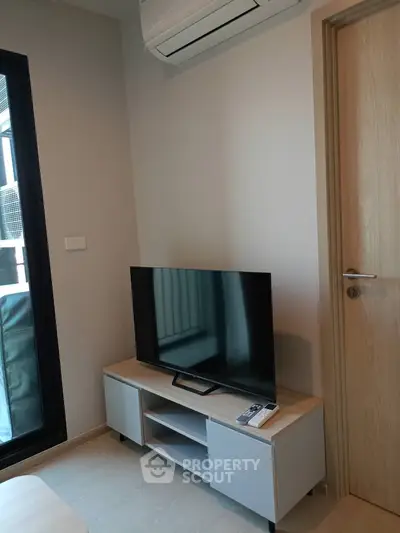 Modern living room with sleek TV setup and air conditioning